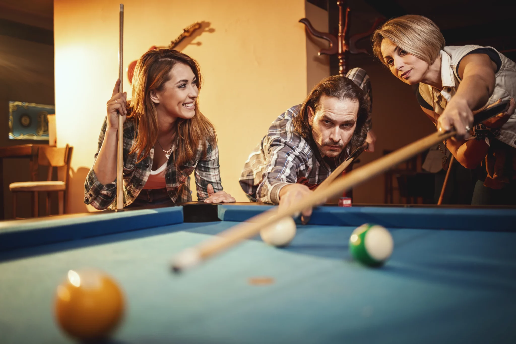 young-smiling-cheerful-friends-are-playing-billiards-bar-after-work-they-are-involved-recreational-activity-2048x1365